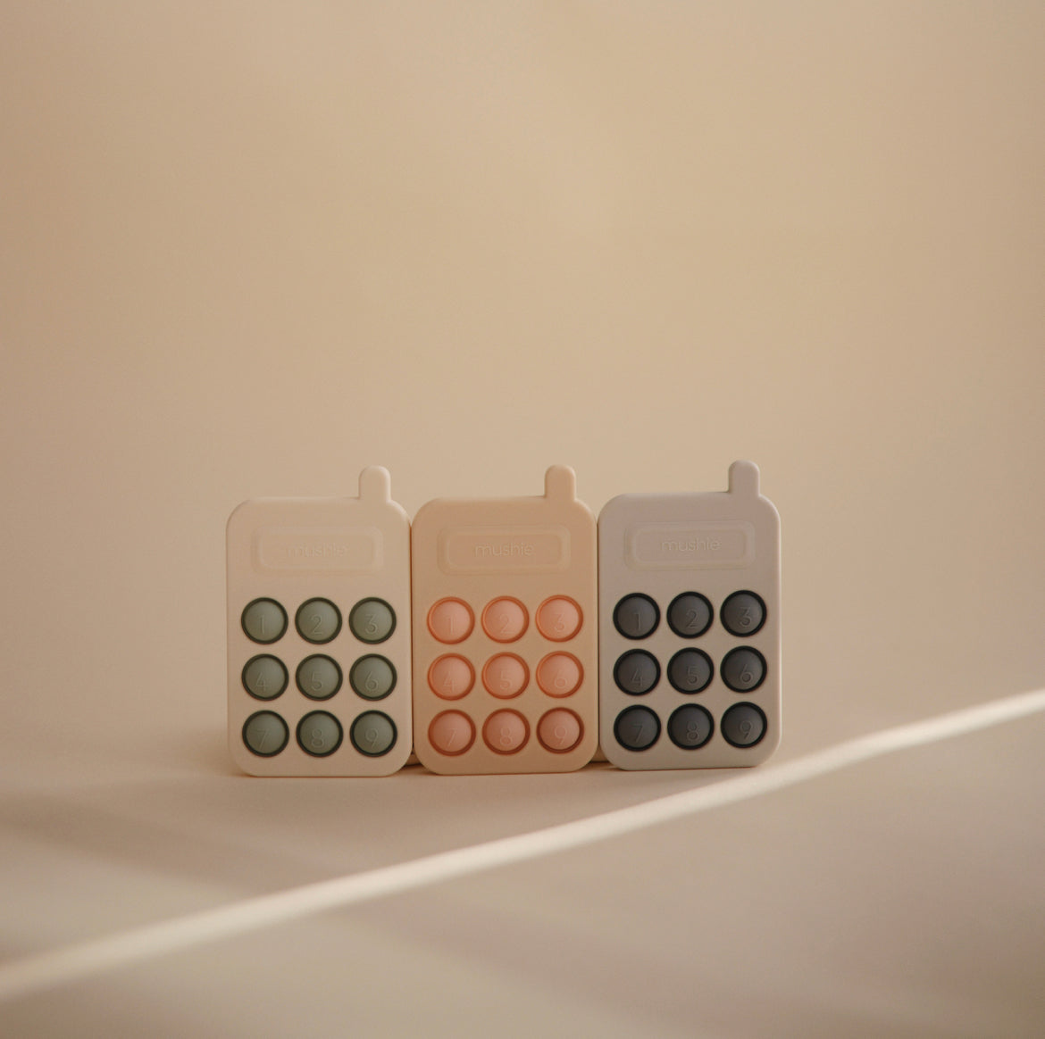 Mushie Phone Press Toy in Tradewinds